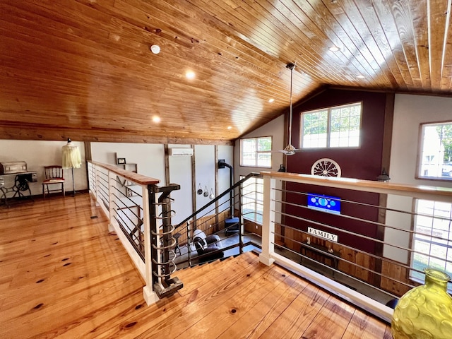 additional living space featuring vaulted ceiling, plenty of natural light, hardwood / wood-style floors, and wooden ceiling