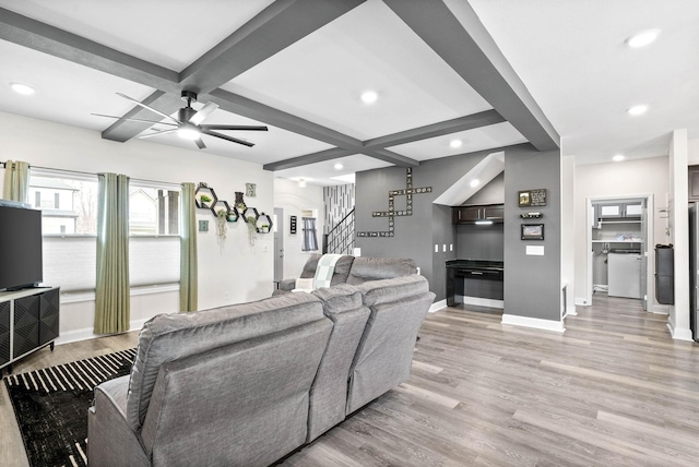 living room with beamed ceiling, ceiling fan, coffered ceiling, and light wood-type flooring