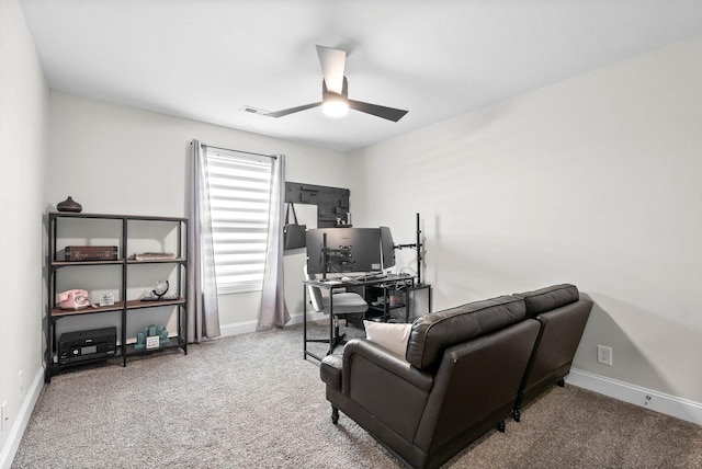 carpeted office space with ceiling fan