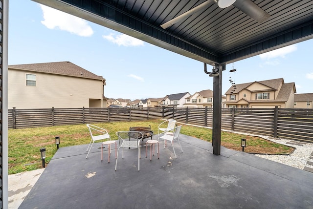 view of patio featuring ceiling fan and an outdoor fire pit