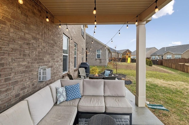 view of patio / terrace with an outdoor living space with a fire pit and a playground