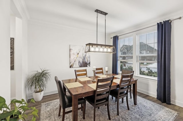 dining room featuring crown molding and dark hardwood / wood-style floors