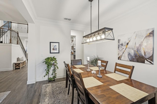 dining area with crown molding and dark hardwood / wood-style flooring