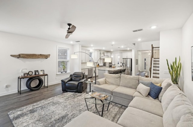 living room featuring dark hardwood / wood-style floors and ceiling fan