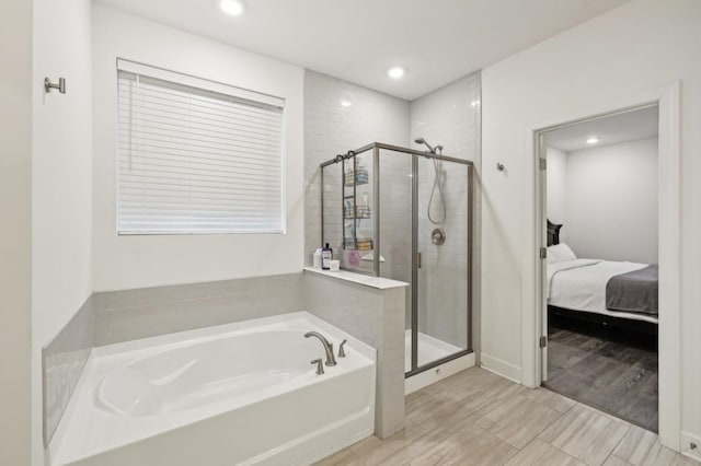 bathroom featuring shower with separate bathtub