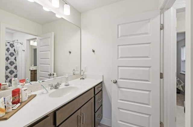 bathroom featuring vanity and curtained shower