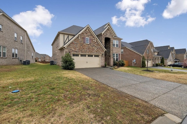 view of front of property with a garage, a front yard, and cooling unit