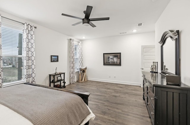 bedroom with ceiling fan and dark hardwood / wood-style floors