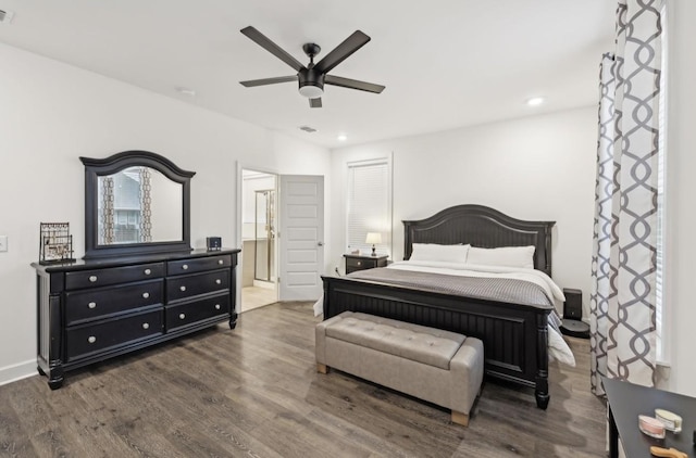 bedroom featuring connected bathroom, dark hardwood / wood-style floors, and ceiling fan