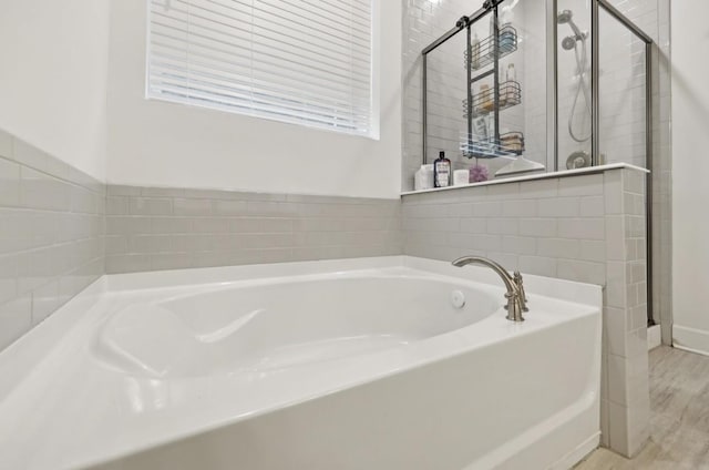 bathroom featuring a bath and wood-type flooring