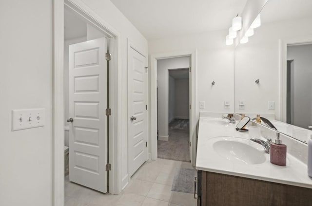 bathroom featuring tile patterned floors, vanity, and toilet