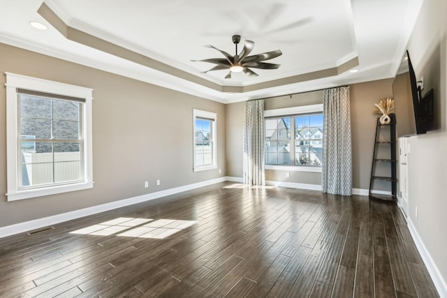 spare room featuring dark hardwood / wood-style floors and a tray ceiling