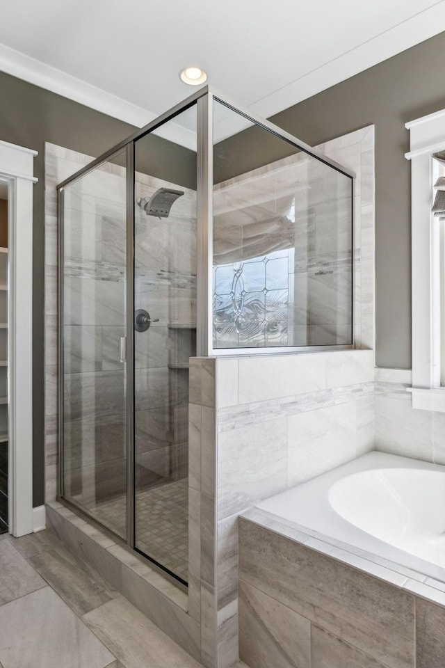 bathroom featuring separate shower and tub