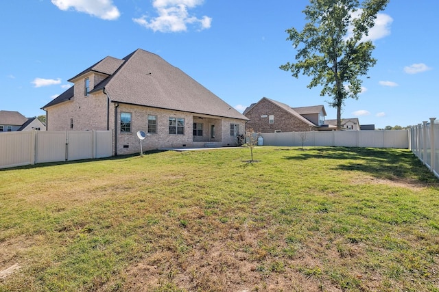 back of house featuring a yard