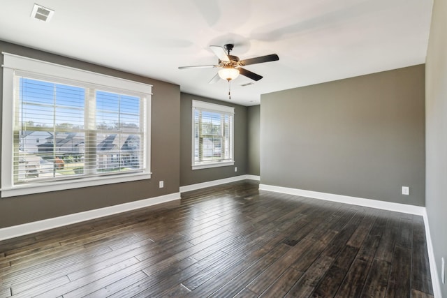 spare room featuring dark hardwood / wood-style floors and ceiling fan