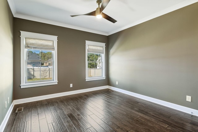 spare room featuring dark wood-type flooring, ceiling fan, and crown molding