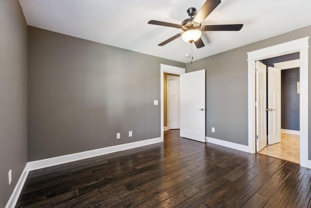 unfurnished bedroom with ceiling fan and dark hardwood / wood-style flooring