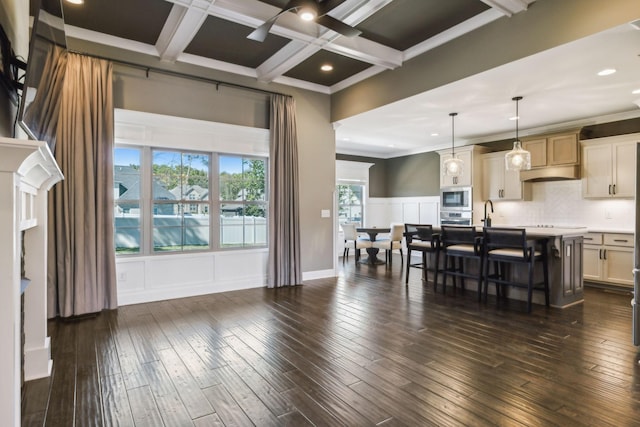 interior space featuring crown molding, coffered ceiling, dark wood-type flooring, and beam ceiling