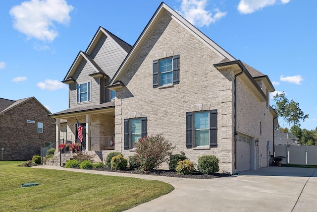 view of front of property with a garage, a porch, and a front lawn