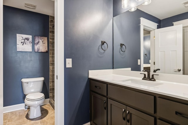 bathroom featuring tile patterned flooring, vanity, and toilet