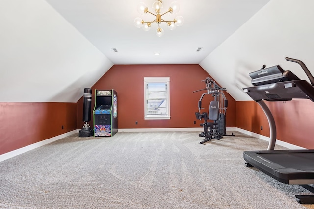 workout room with a notable chandelier, vaulted ceiling, and carpet flooring