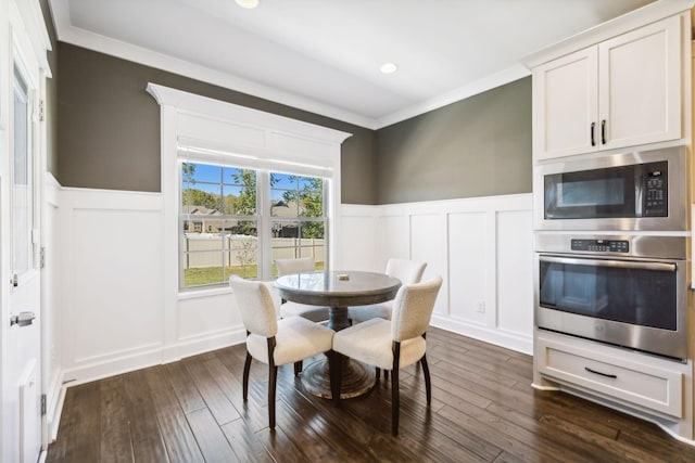 dining area with crown molding and dark hardwood / wood-style flooring