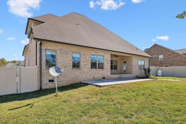 rear view of house featuring a patio, ceiling fan, and a lawn