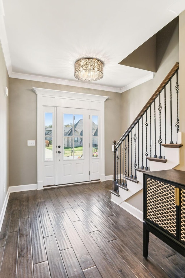 foyer entrance featuring ornamental molding and dark hardwood / wood-style flooring