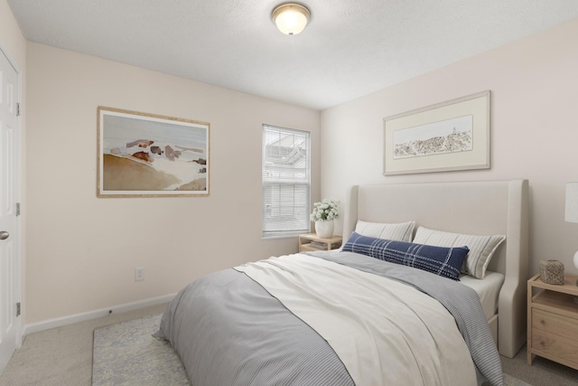 bedroom featuring light colored carpet