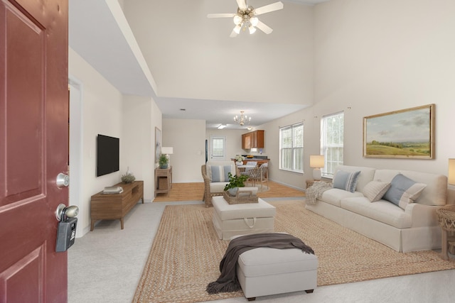 carpeted living room with a towering ceiling and ceiling fan with notable chandelier