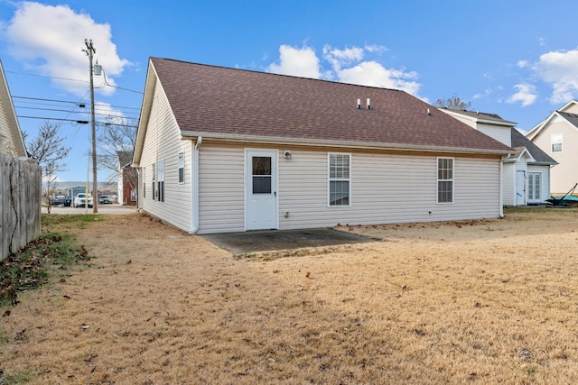 back of house with a lawn