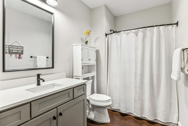 bathroom with vanity, toilet, a shower with shower curtain, and concrete floors