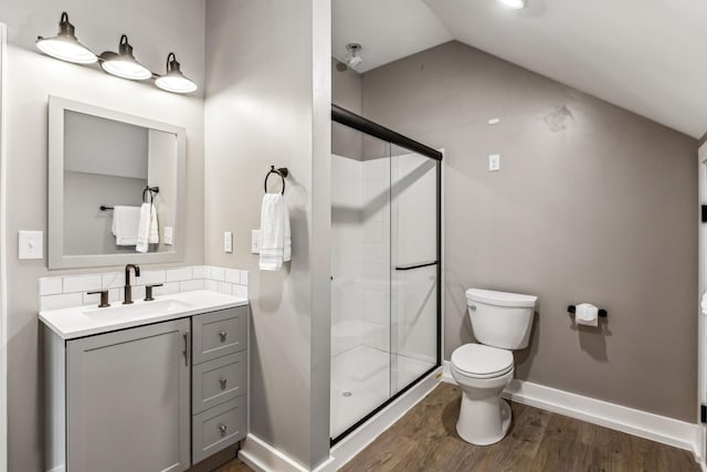 bathroom with an enclosed shower, hardwood / wood-style floors, vaulted ceiling, and toilet