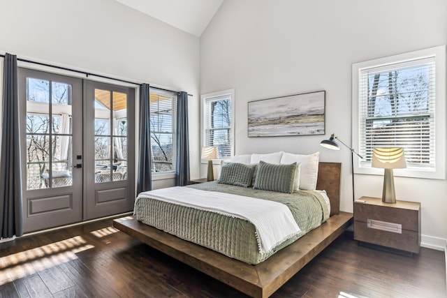 bedroom featuring dark hardwood / wood-style floors, access to exterior, high vaulted ceiling, and french doors