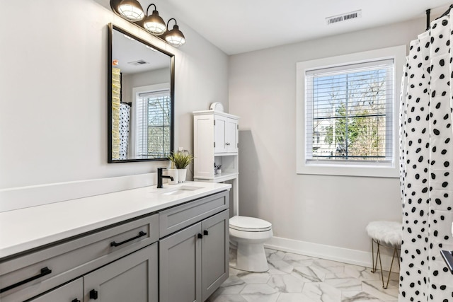 bathroom featuring vanity, curtained shower, and toilet