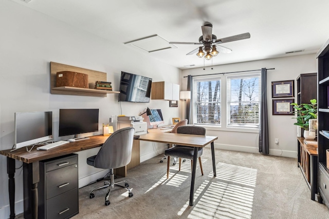 carpeted office space with ceiling fan