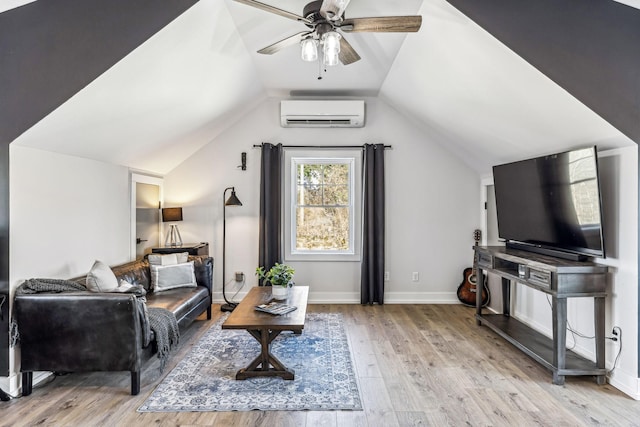 living room featuring vaulted ceiling, a wall mounted air conditioner, ceiling fan, and light wood-type flooring