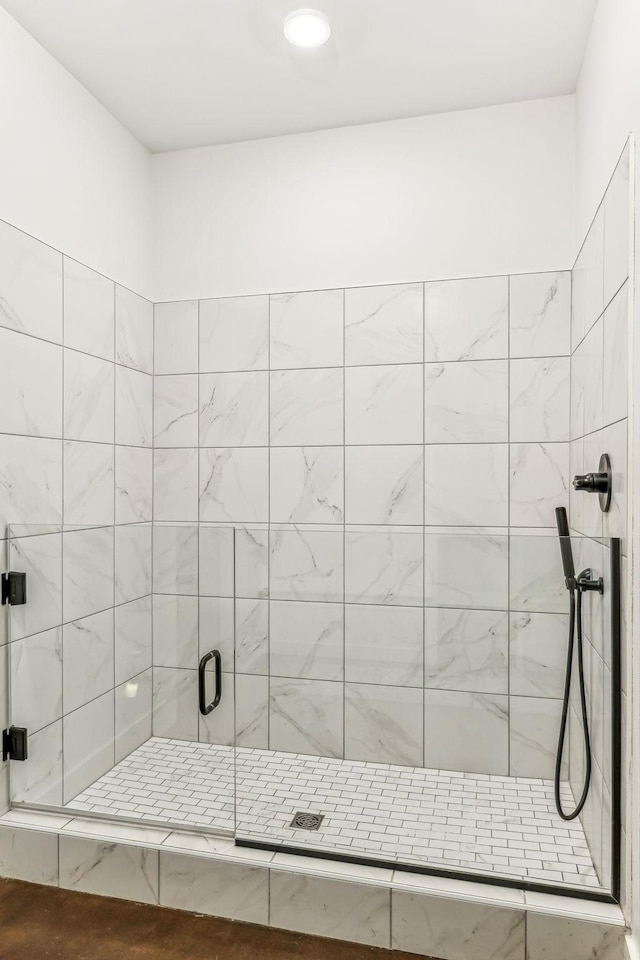 bathroom with a shower with shower door