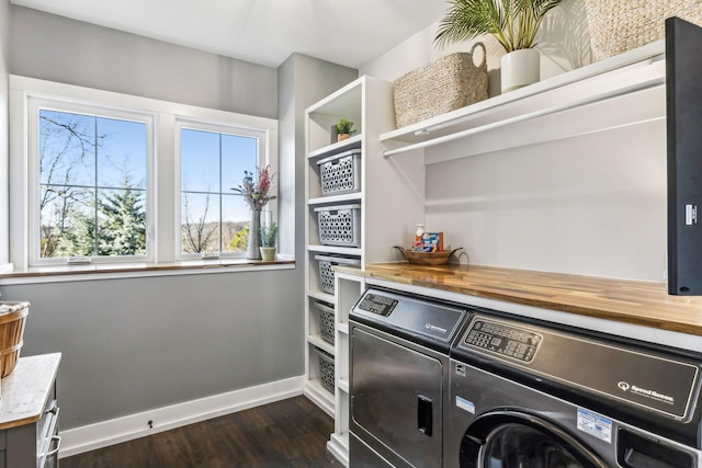 laundry room with washing machine and dryer and dark wood-type flooring