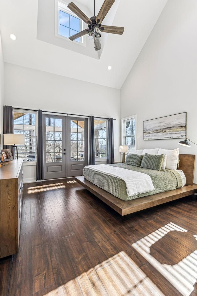 bedroom featuring multiple windows, high vaulted ceiling, dark hardwood / wood-style flooring, and french doors