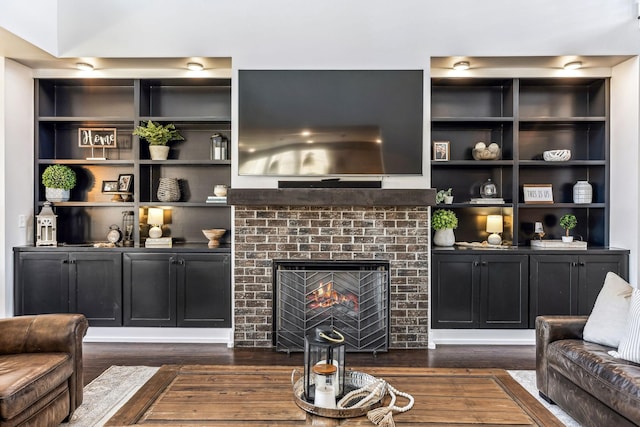 living room with dark hardwood / wood-style floors and a fireplace