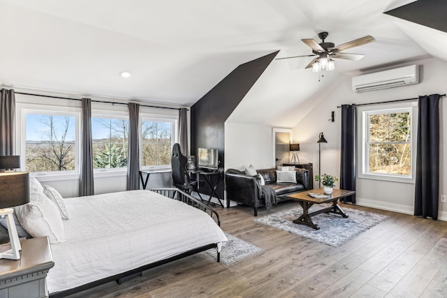 bedroom featuring multiple windows, vaulted ceiling, wood-type flooring, and a wall unit AC