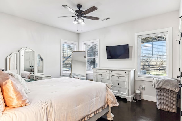 bedroom featuring ceiling fan and dark hardwood / wood-style flooring