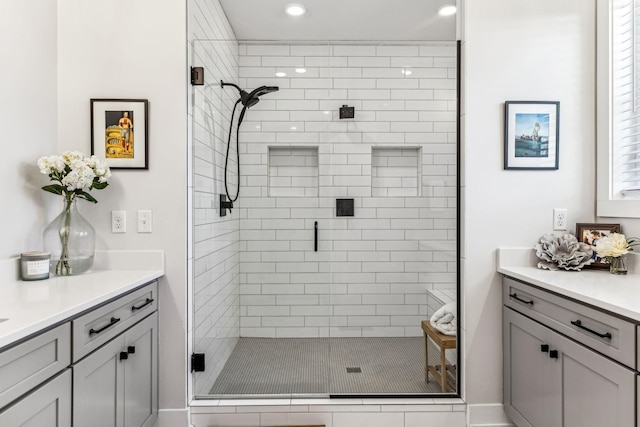 bathroom featuring vanity and an enclosed shower