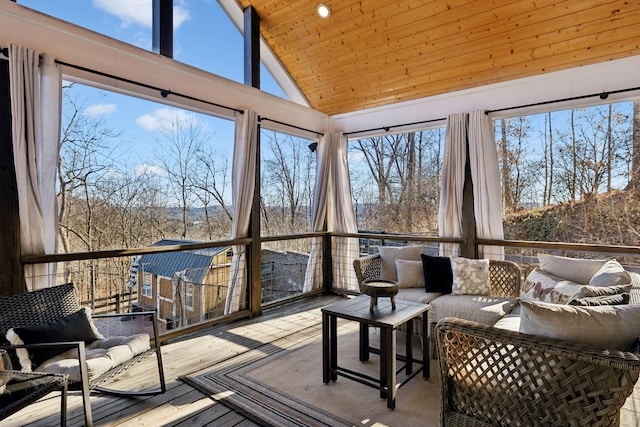 sunroom with lofted ceiling, a wealth of natural light, and wood ceiling