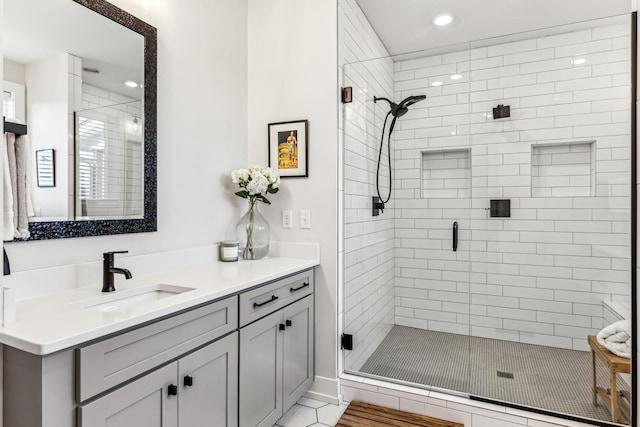 bathroom with vanity and an enclosed shower