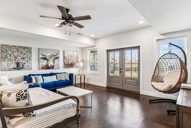 living room featuring a healthy amount of sunlight, ceiling fan, and french doors