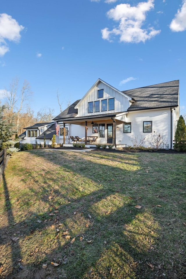 back of house with a porch and a yard