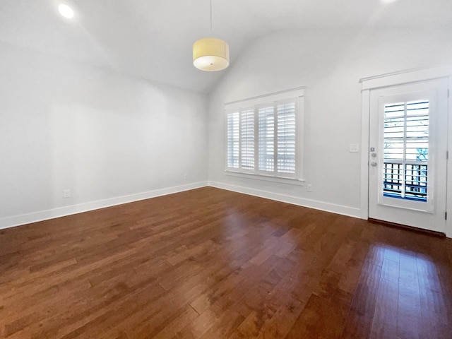 unfurnished room featuring dark wood-type flooring, lofted ceiling, and a healthy amount of sunlight