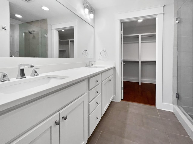 bathroom with vanity, tile patterned flooring, and a shower with door